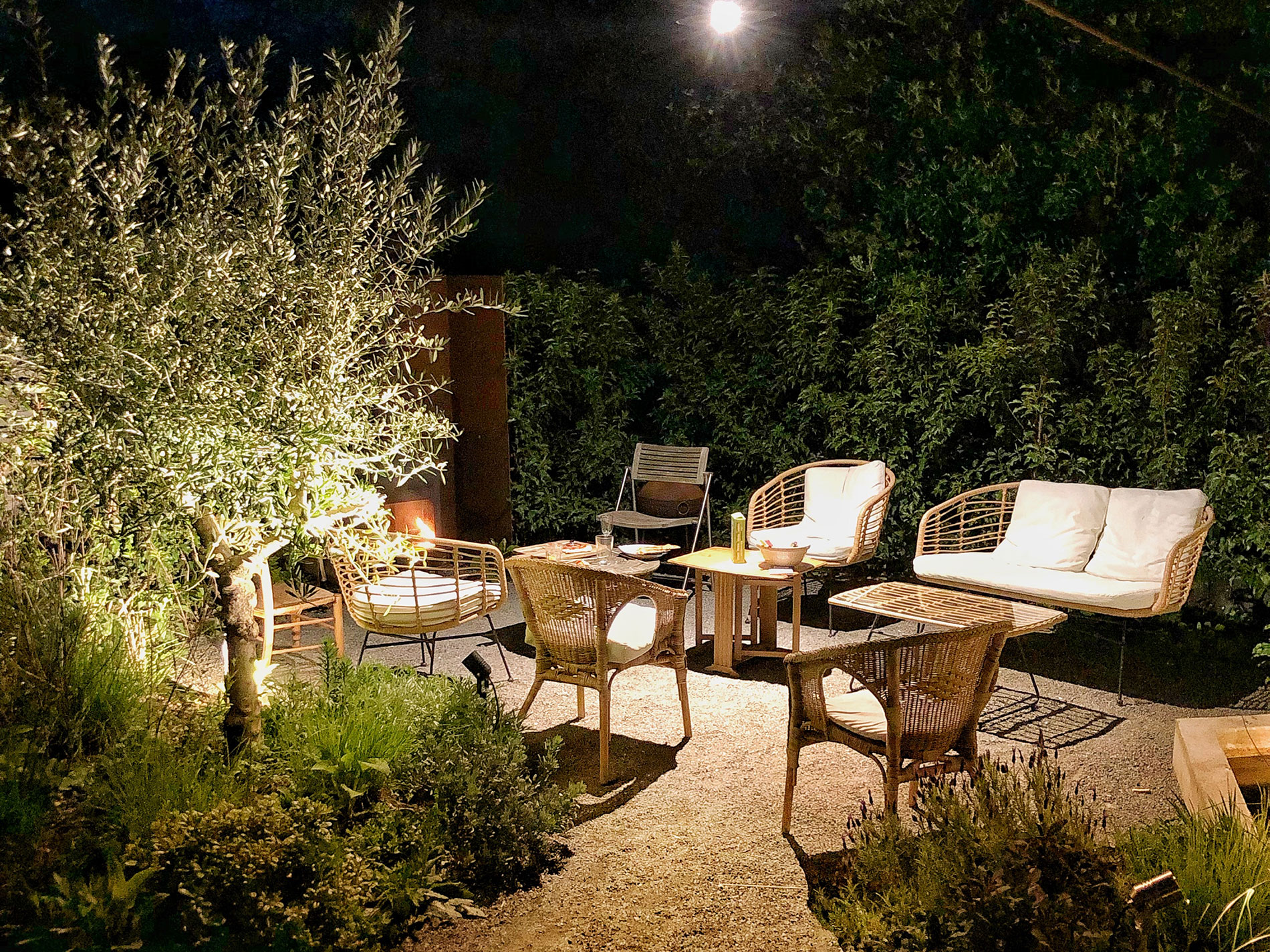 This Mediterranean style garden in Tring pictured at night shows how atmoshere can be created with garden lighting